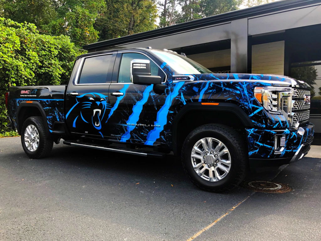 Pickup truck wrapped with sports graphics.