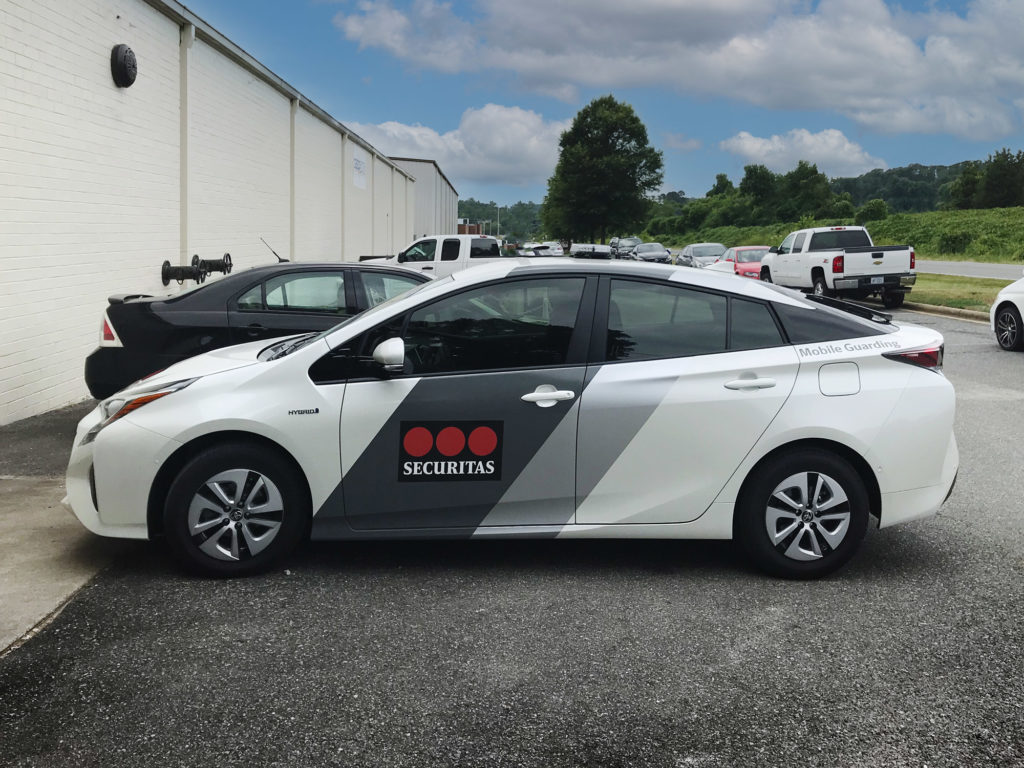Toyota Prius with graphic wrap for a security service.