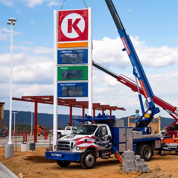 Casco installers putting up a gas station price sign