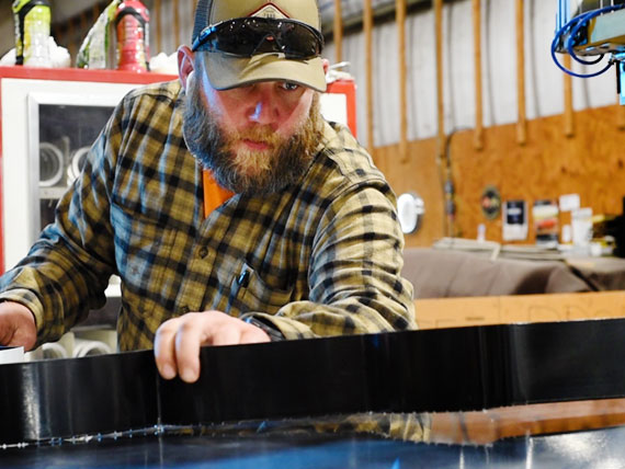 Assembly technician building channel letters for a sign.