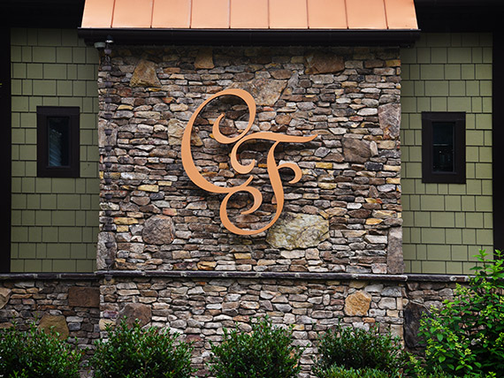 Letters C and F in a script font created in metal with a copper look