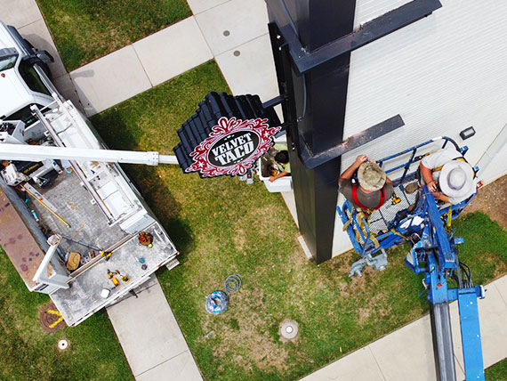 Overhead photos of sign installers working