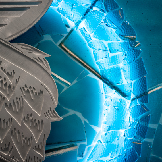 Glass mosaic and metal logo details.